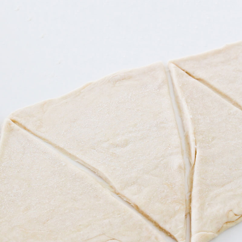 The puff pastry has been cut into large triangles.