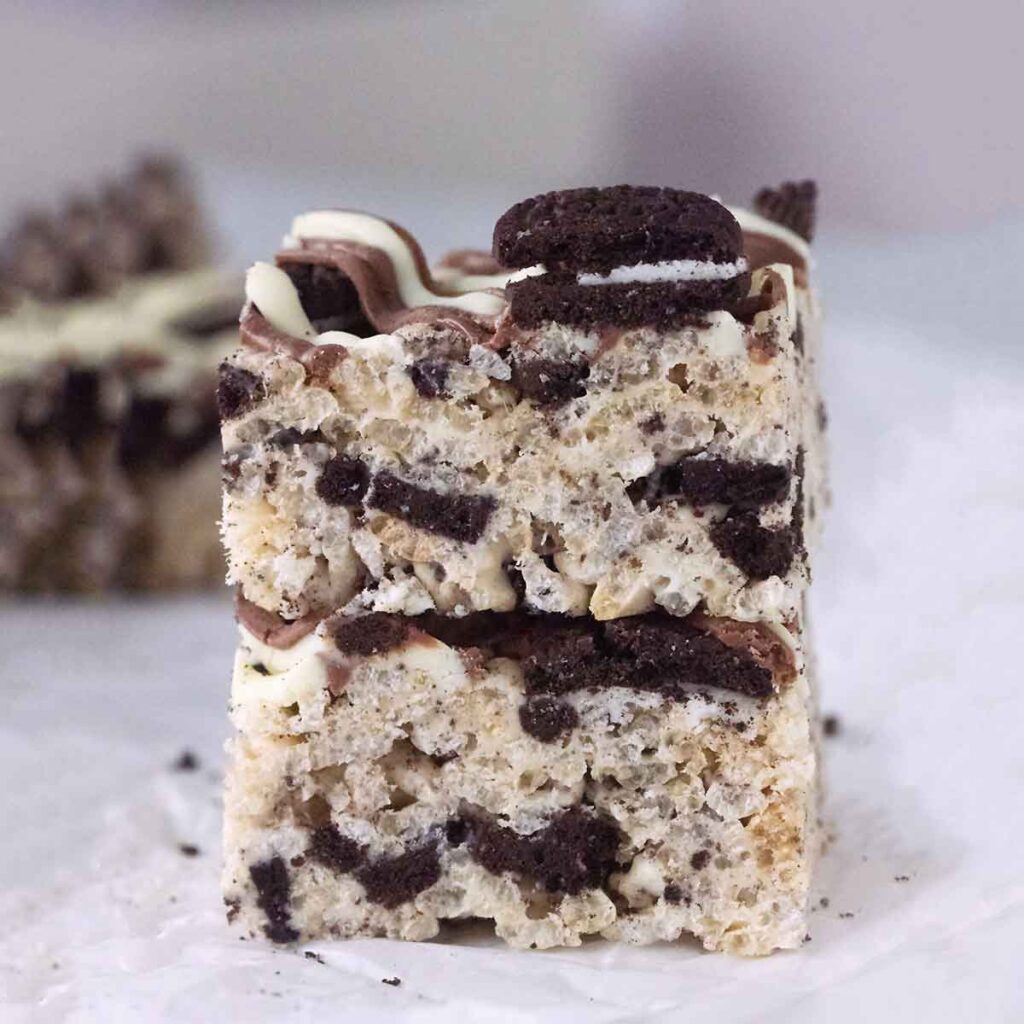 two squares of oreo rice krispie treats stacked on a white table.