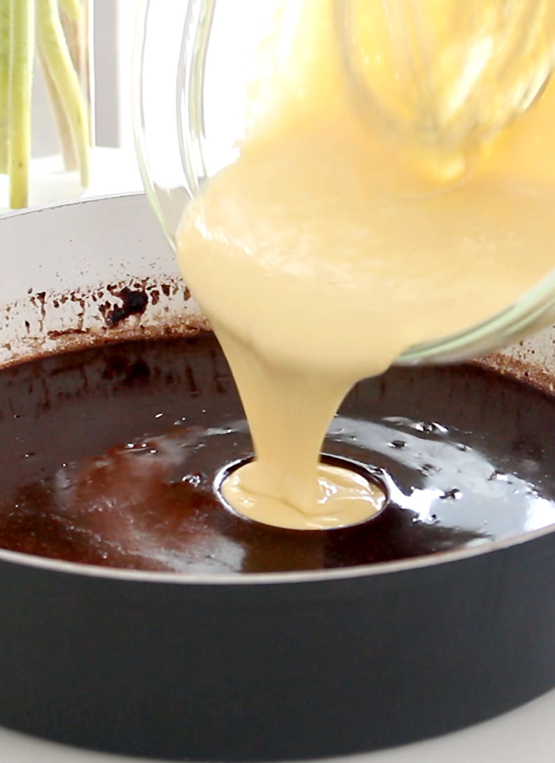 egg batter is poured into chocolate cupcake batter in a pan