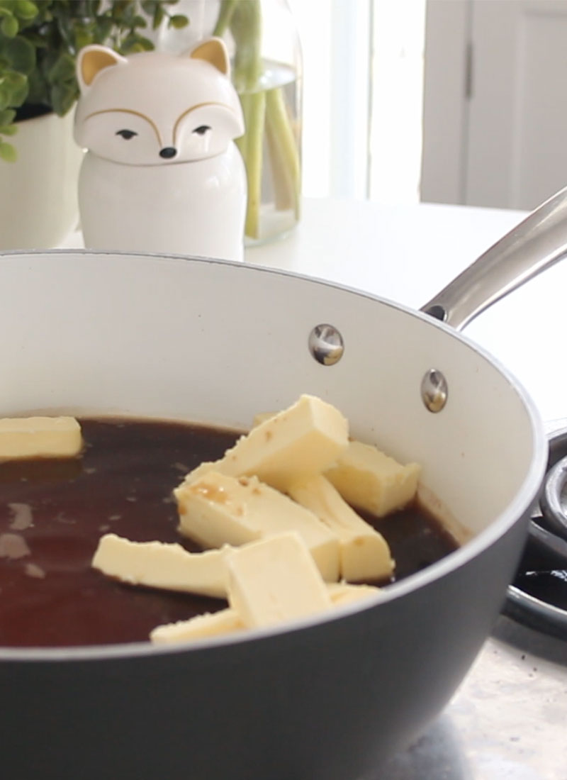 A large pot filled with guinness beer and sticks of butter