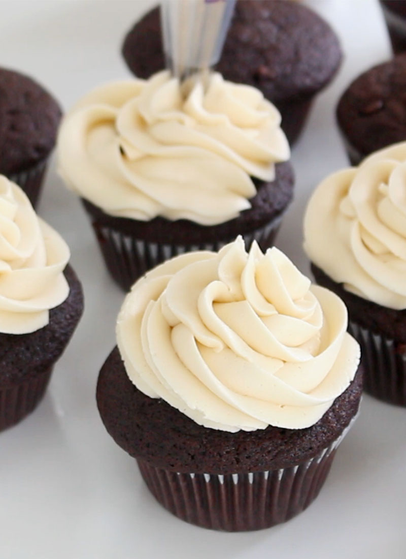 chocolate cupcakes topped with swirls of white buttercream