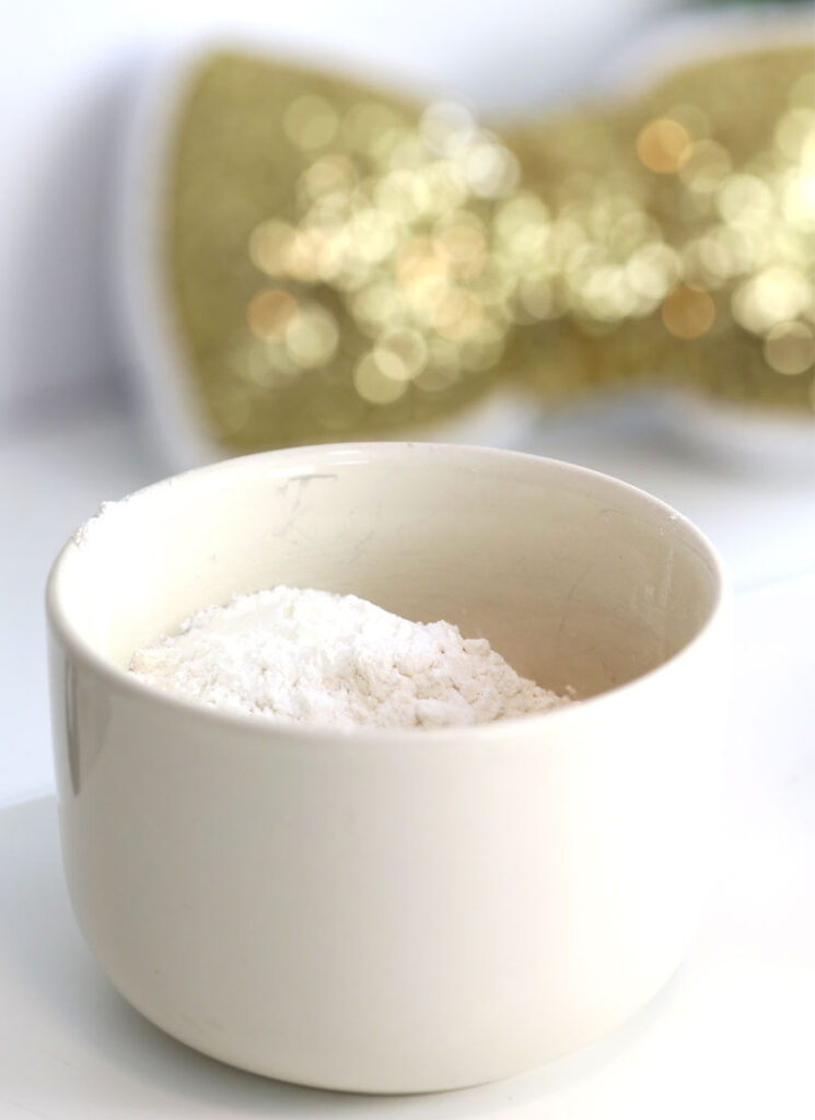 A white ceramic bowl contains the dry ingredients for pancakes.