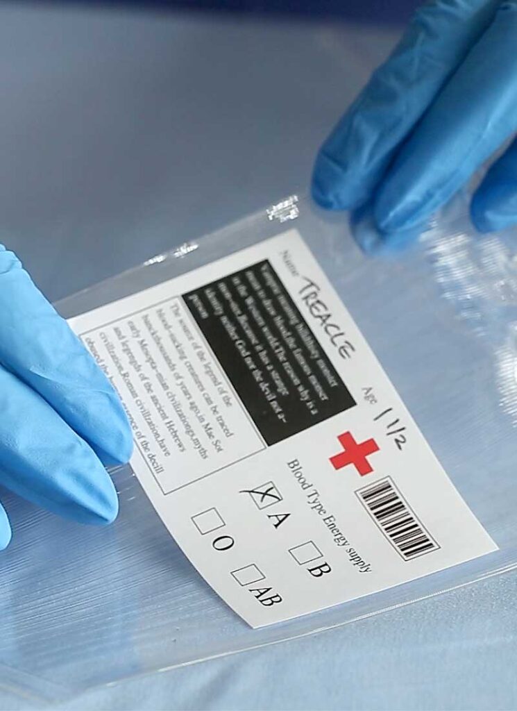 An empty plastic blood bag on a blue table.