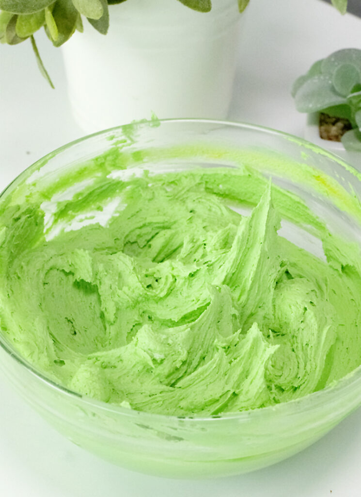 bright green buttercream in a glass bowl