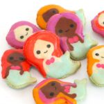 mermaid-shaped macarons on a white table