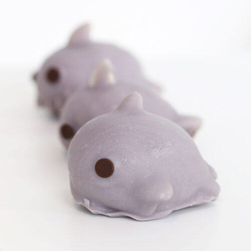3 grey shark truffles in a line on a white table