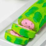 A sliced watermelon roll cake on a plate.