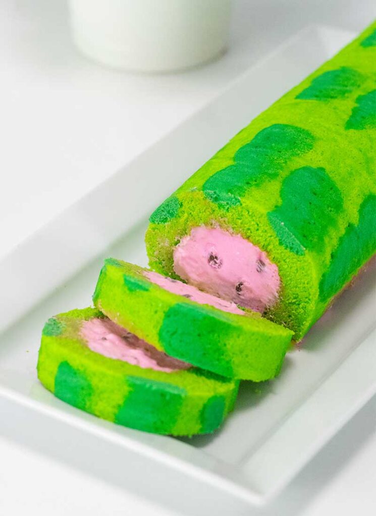 A sliced watermelon roll cake on a plate.