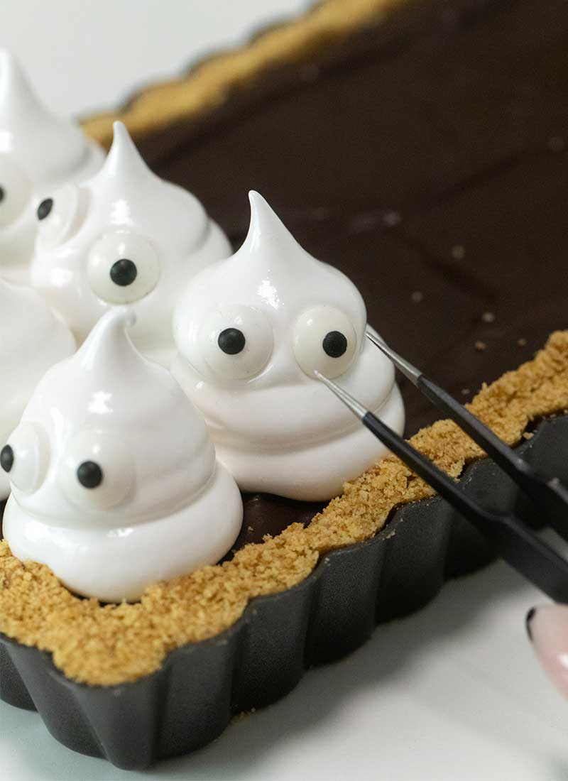 stick candy eyes onto ghosts