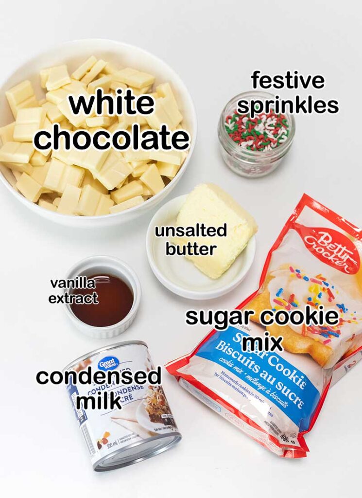 Ingredients for sugar cookie fudge are displayed on a white surface.