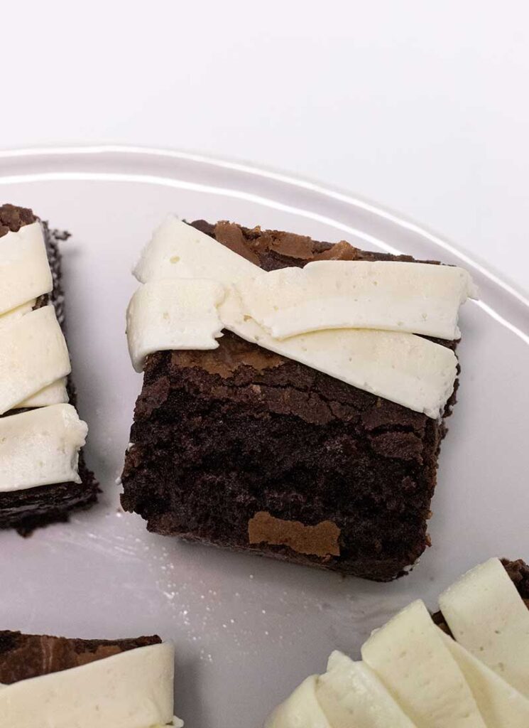 A brownie with two lines of buttercream bandages piped on top.
