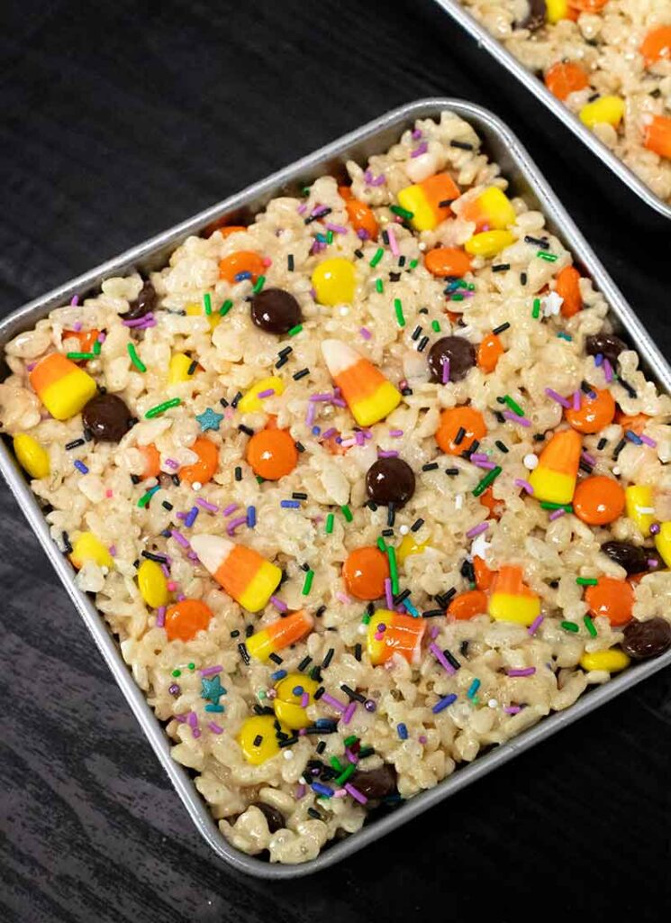 The rice crispy treat mix has been pressed into a square pan.